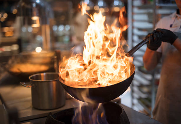 istock Chef Cooking with flaming  wok 2221804671