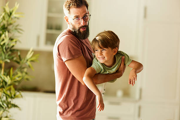istock Playful father having fun with his small son at home. 2221806461