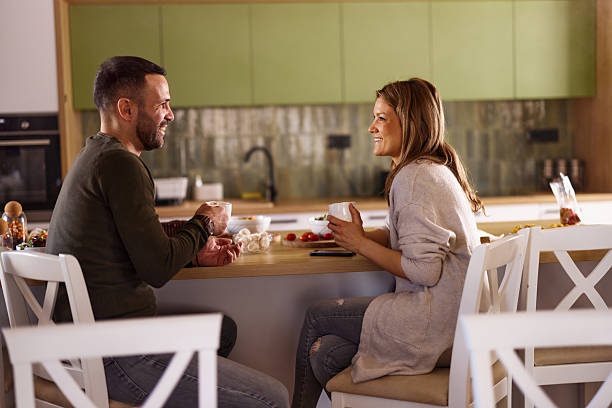 istock Happy couple talking during coffee time in dining room. 2221807426