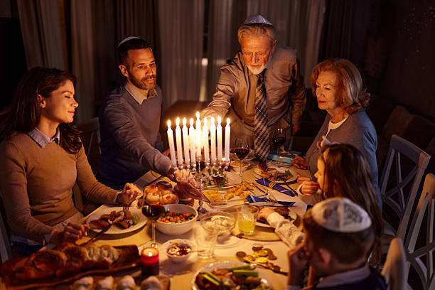 istock Arranging candles on Menorah before dinner on Hanukkah! 2221807752