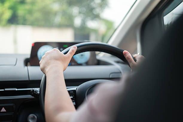istock A car driver is holding and controlling on steering wheel. 2221809002