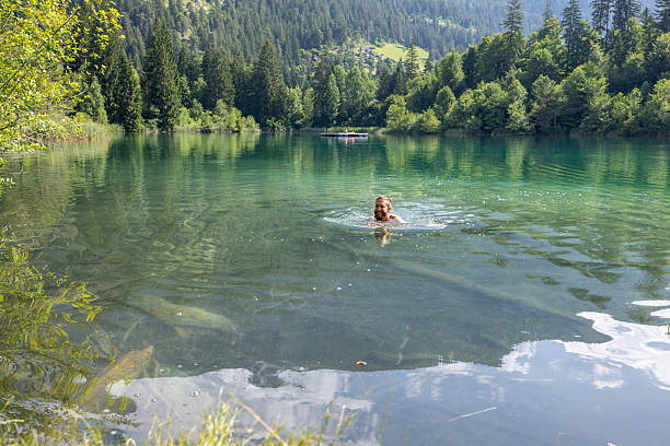 istock Man Swimming in a Tranquil Mountain Lake 2221812905