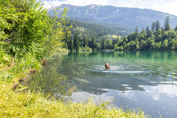 istock Man Swimming in a Tranquil Mountain Lake 2221812909