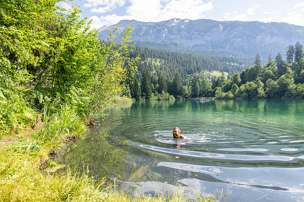 istock Man Swimming in a Tranquil Mountain Lake 2221812943