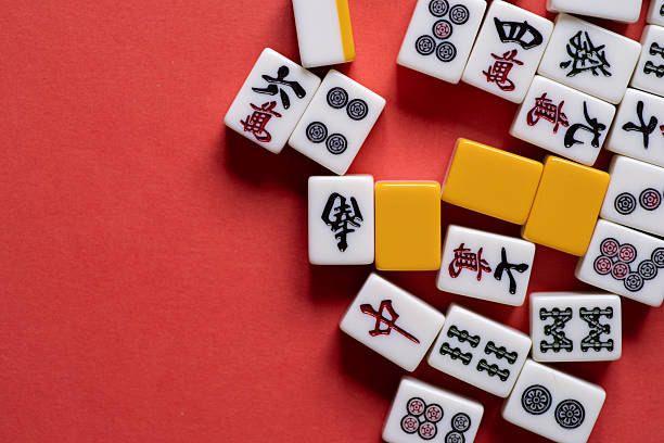 istock Mahjong tiles lined up on a red background 2221813102