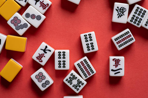 istock Mahjong tiles lined up on a red background 2221813184
