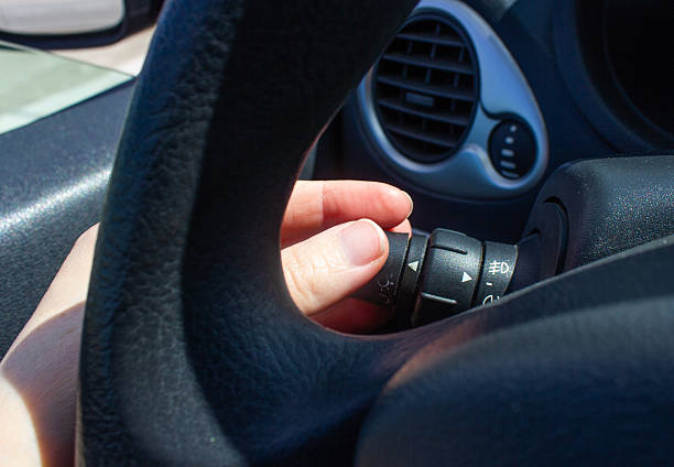 istock car interior, car dashboard, steering wheel, headlight adjustment, low beam in a car, 2221814849