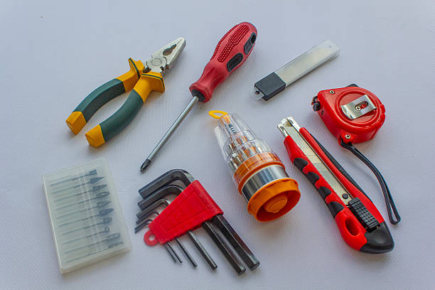 istock construction tools, repair tools on a white background, photo background builder's day, knife, screwdriver, pliers, tape measure, blades, screwdriver set, drills 2221814952