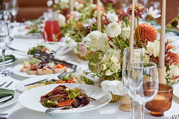 istock Graceful autumn aesthetics table setting, arranged flowers under natural light. Cozy holidays table setup 2221815230