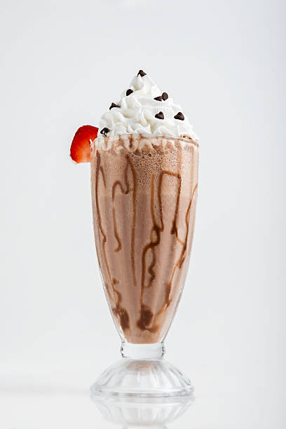 istock A chocolate milkshake, generously topped with whipped cream, chocolate chips 2221818937