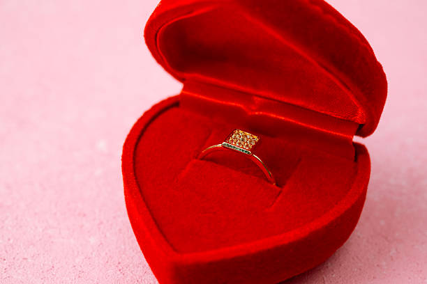 istock Square diamond ring in red heart jewelry box on pink background 2221820130
