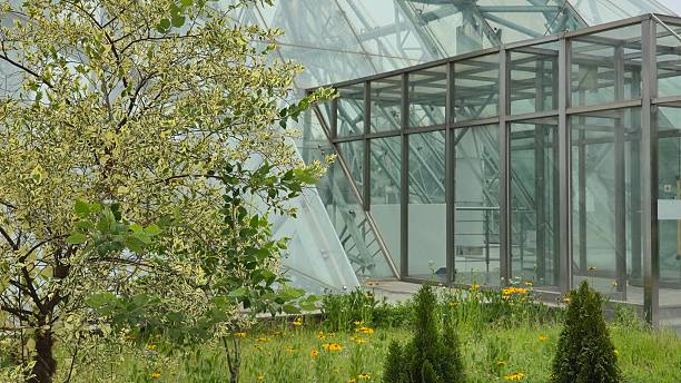 istock Contemporary Glass Structure Surrounded by Garden Landscape and Trees 2221820766
