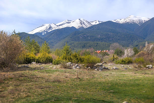 Bansko, Bulgaria spring woods and Pirin snow mountain peaks, panorama of bulgarian all season resort
