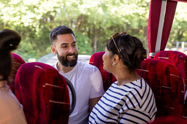 istock Couple Converse on a Coach Bus 2221827211