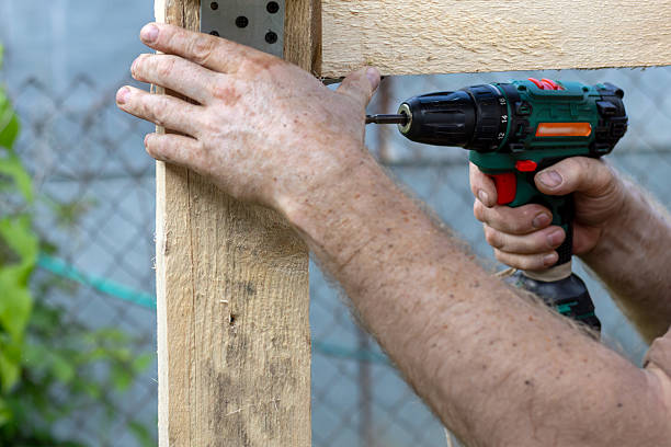 istock Close-up of men's hands using drill to assemble wooden structure 2221828489