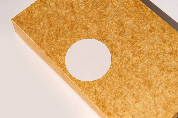 istock Brown textured box with circle label on white background 2221829632