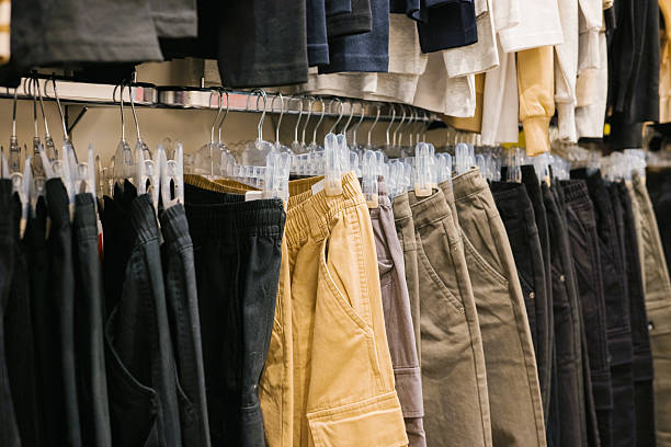 istock Assorted casual pants hanging in retail store display 2221829704