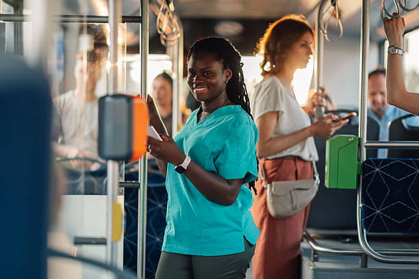 istock Young nurse smiling while riding the bus after work 2221831391