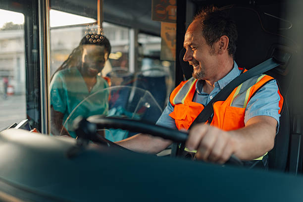 istock Bus driver smiling and talking with a nurse at the bus stop 2221831567