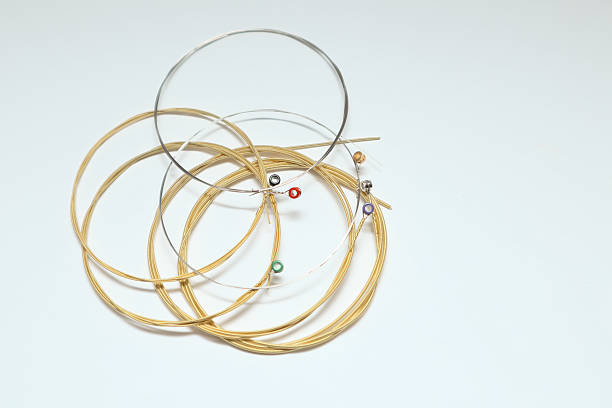 istock Twisted new guitar strings on white background. New acoustic guitar strings. 2221834652