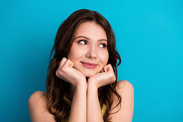 istock Young attractive woman posing with charming expression against vibrant blue background 2221834833