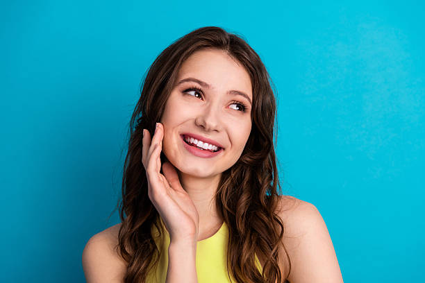 istock Charming young woman with a cheerful expression posing against a blue background wearing a yellow outfit capturing stylish vibes 2221834839