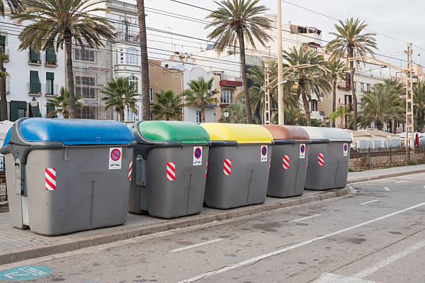 istock Colorful recycling bins in urban setting with palm trees 2221835304