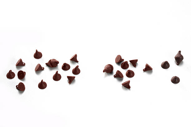 istock Chocolate chips curls scattered isolated on white background. Brown choco cocoa food ingredient 2221837588