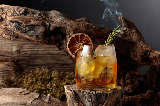 istock An old-fashioned cocktail over ice on an old wooden stump. 2221838086
