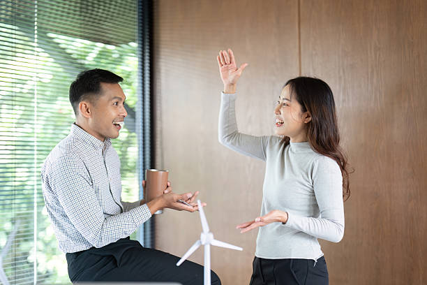 istock Dynamic Energy Discussion. Professionals engaged in conversation about renewable energy project. 2221839143