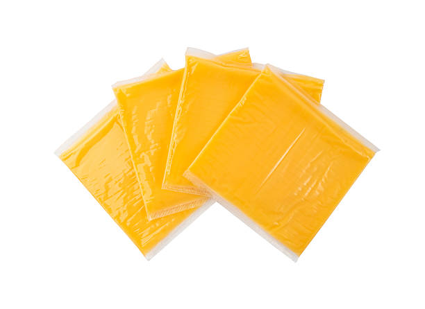 istock American cheese, processed cheese slice, wrapped thin yellow cheddar in a plastic package 2221839601