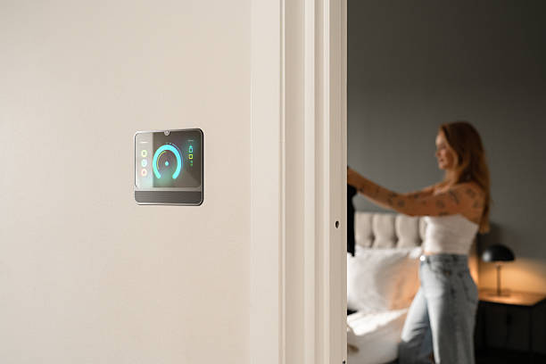 istock Modern Smart Home Device Displaying Controls with Woman in Background 2221839663