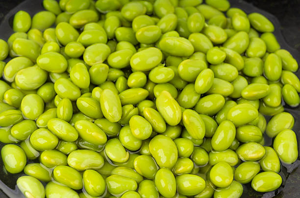 istock Edamame beans bowl textured background. Green soy bean pattern, many cooked young soybeans 2221840358