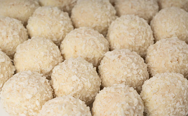istock Coconut candies texture background, coco balls pattern. White truffle ball wallpaper, indian ladoo 2221840419