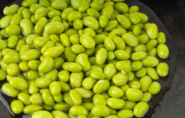 istock Edamame beans bowl textured background. Green soy bean pattern, many cooked young soybeans 2221840534