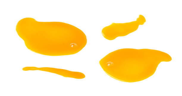 istock Spilled orange juice isolated, mango smoothie puddle, liquid stain, carrot juice splatter 2221840854