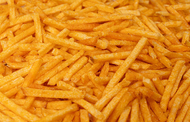 istock Fried chips sticks texture background, finger potato ketchup flavored chips pattern, shoestring fries 2221840898