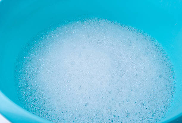 istock Hand laundry washing clothes in blue plastic basin 2221841662