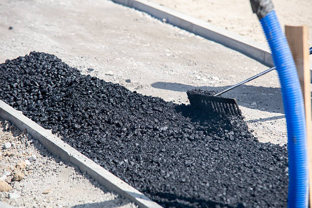 istock Construction workers in high-visibility gear are applyin gfresh hot asphalt to roadway surface 2221842744