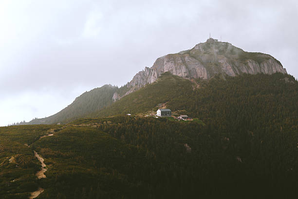 A road leading to a lonely house on a mountaintop.
