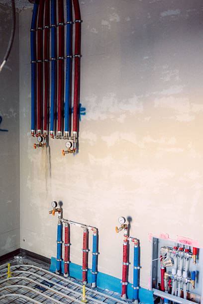 istock Underfloor heating system installation with manifold and pipes on concrete surface 2221844056
