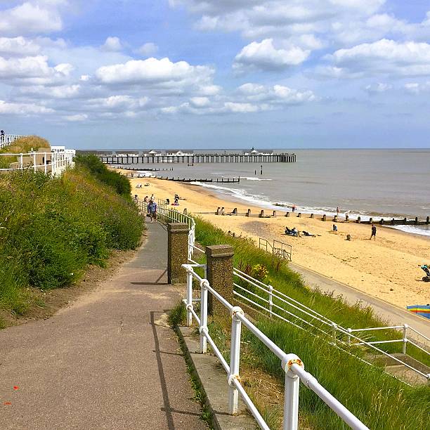 istock Scenic coastal walkway with pier under sunny sky, people strolling by beach and enjoying summer leisure—inviting seaside atmosphere ideal for travel and lifestyle visuals 2221844922