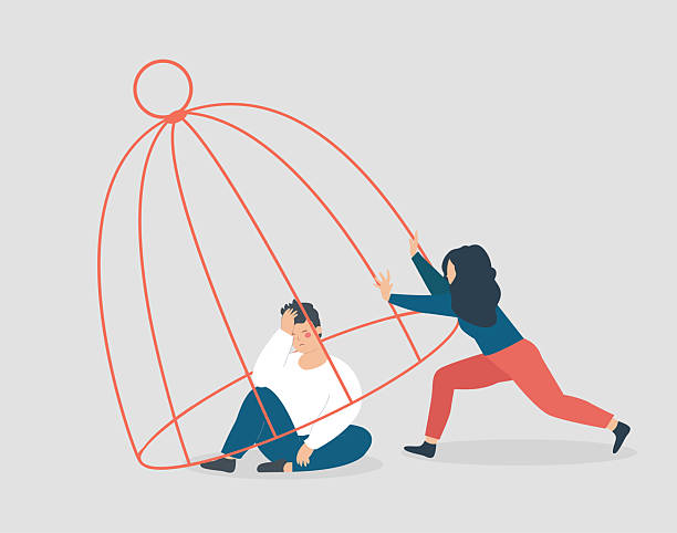 istock Psychologist helps a man locked inside a cage to be free. Rehabilitation from depression, addiction, and therapy. Concept of psychiatric support, recovery, and self-awareness. 2221847248