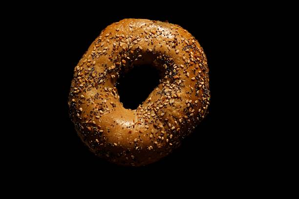 istock Close-up of an everything bagel with seeds. 2221854178