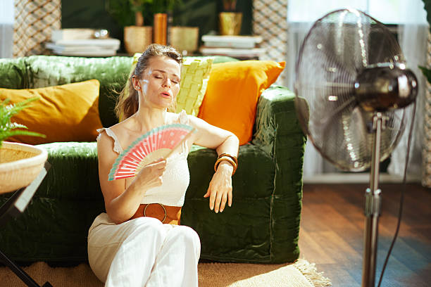 istock Battling Summer Heat with Fans Indoors 2221855647