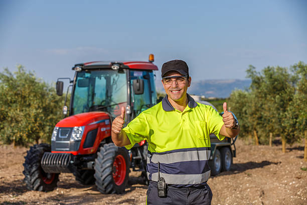 Male farmer working in the crop field in the morning. He is dressed in work clothes. Interior of work van. Day in the life series.