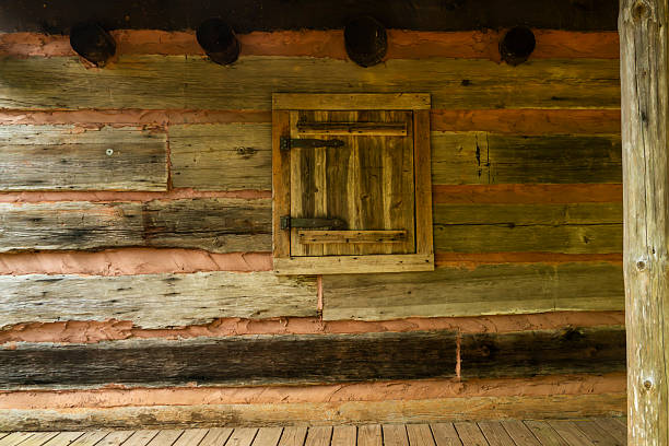 istock A shuttered window on an old log cabin 2221859312