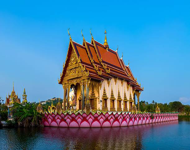 istock Ornate Golden Thai Temple on Lotus Base Reflected in Water 2221859672