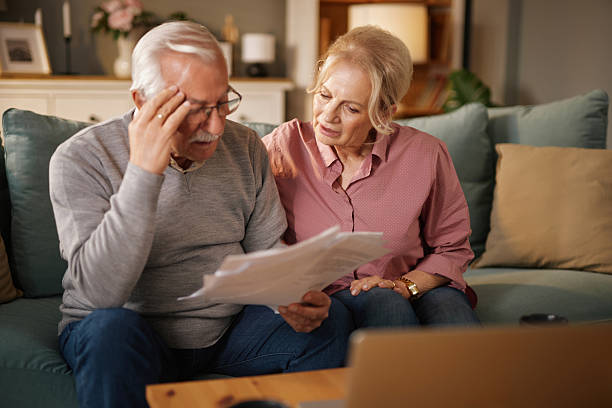istock Worried senior couple reading documents at home 2221859893