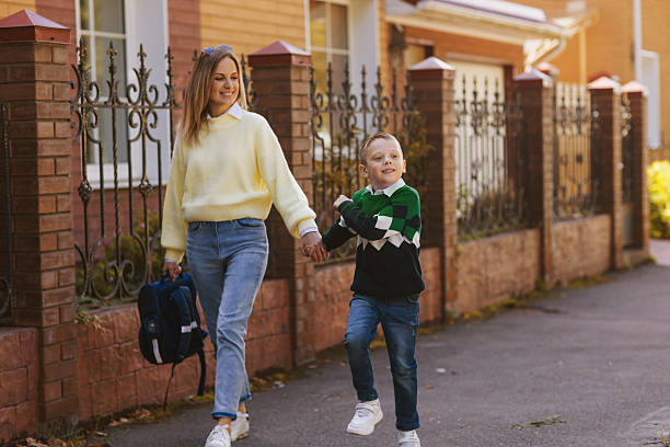 istock mother and kid on first school day side view 2221860599